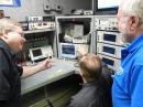 Alan Wolke, W2AEW, Senior Applications Engineer for Tektronix Corporation (center) demonstrates the MDO4104B-3 oscilloscope for ARRL Laboratory Test Engineer Bob Allison, WB1GCM (left) and ARRL Laboratory Manager Ed Hare, W1RFI (right).