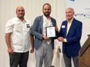 Ezequiel Prado, HI3R (left), and Otis Vicens, NP4G (center), accept the Northern California DX Foundation’s “DXcellence” award for the KP5/NP3VI Expedition from NCDXF Vice President Craig Thompson, K9CT. [Rich Moseson, W2VU, photo]