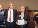 Andy Smolenski, KI5YLX and David Gilpin, K5GIL, receive a proclamation from city officials in Carrollton, Texas where June 22 –25 was declared Amateur Radio Week. [Mike Brown, W5MDB, photo]
