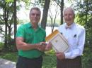 John Soderberg, W1AKV (right), receives an award in 2004 from Richard Monahan, K4FPP, marking his 50 years of QCWA membership and for being President of QCWA Chapter 149. [Photo courtesy of Jim Kyle, KC1SD]
