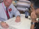 ARRL Membership and Volunteer Programs Manager Dave Patton, NN1N, checks DXCC applications at Ham Fair in Tokyo. [Photo courtesy of David Sumner, K1ZZ]