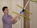 A Yagi made from measuring tape and a simple attenuator box are all that it takes to turn a 2 meter handheld transceiver into a direction-finding system. Jay Thompson W6JAY, a medal winner at several USA ARDF Championships, shows some of his gear at the 2005 ARRL Southwestern Division Convention in Riverside, California. [Joe Moell, K0OV, Photo]