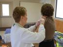 A nurse gives Karen Feichtner, KC8BZL, a hepatitis A vaccine. Clinic organizers suggested the ARES members who assisted with the clinic get vaccinated. [Robert Spratt, N8TVU, Photo]