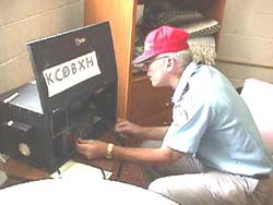 ARES Coordinator Don Sanders, W0KTL, sets up an emergency base station at the Pine Ridge Red Cross headquarters. [Trina Blanks, KB0TYW]